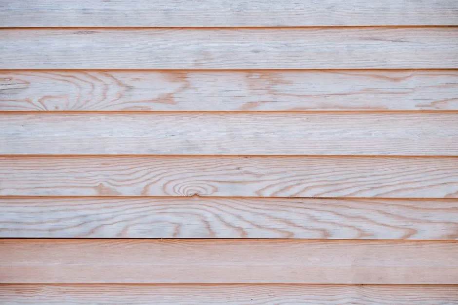 Close-up of a light wooden wall showcasing a natural grain pattern and texture, ideal for design backdrops.