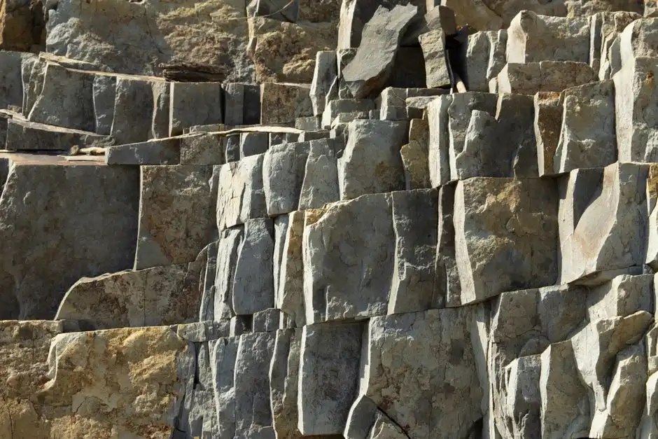 Close-up of a textured stone rock formation, showcasing natural geological structures.