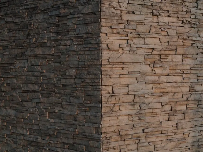 Close-up of a textured stone wall with distinct lighting contrast in Hong Kong.